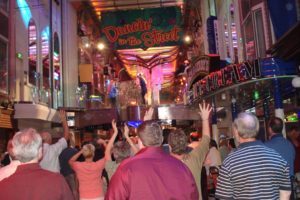 dancing and enjoying an evening performance on the cruise ship's main street